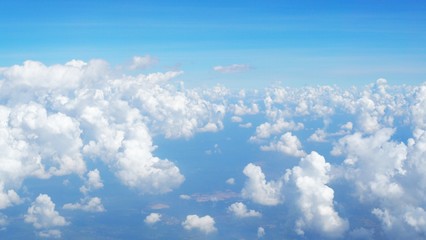 blue sky background with clouds, beautiful cloudscape, view over white fluffy clouds, freedom concept