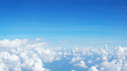blue sky background with clouds, beautiful cloudscape, view over white fluffy clouds, freedom concept