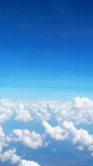 blue sky background with clouds, beautiful cloudscape, view over white fluffy clouds, freedom concept