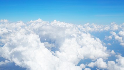 blue sky background with clouds, beautiful cloudscape, view over white fluffy clouds, freedom concept