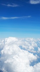 blue sky background with clouds, beautiful cloudscape, view over white fluffy clouds, freedom concept