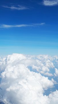 blue sky background with clouds, beautiful cloudscape, view over white fluffy clouds, freedom concept