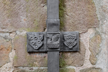 Detailed view of a medieval, leaded gutter seen on the outside of an historical building. Coat of arms can clearly be seen on the lead.