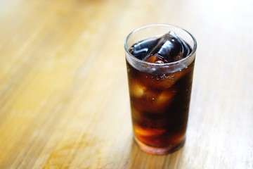 glass of cola with ice cubes