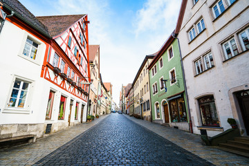 Fototapeta na wymiar ROTHENBURG OB DER TAUBER, GERMANY - MARCH 05: Typical street on March 05, 2016 in Rothenburg ob der Tauber, Germany. It is well known for its well-preserved medieval old town.