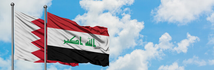 Bahrain and Iraq flag waving in the wind against white cloudy blue sky together. Diplomacy concept, international relations.