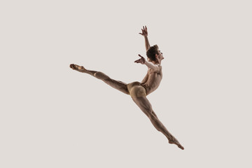 Modern ballet dancer. Contemporary art ballet. Young flexible athletic man.. Studio shot isolated...