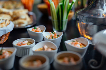 Side shot of shrimp canapies next to water jar