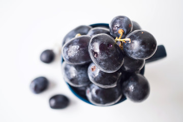 Big black spanish grapes over a white background