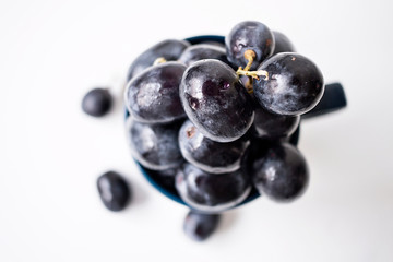 Big black spanish grapes over a white background