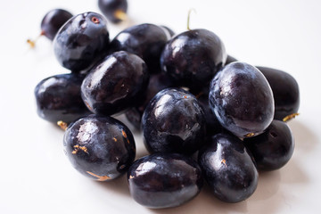 Big black spanish grapes over a white background