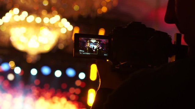 Operator shoots video on camera