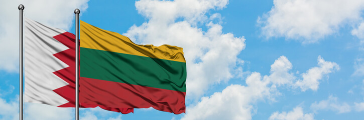 Bahrain and Lithuania flag waving in the wind against white cloudy blue sky together. Diplomacy concept, international relations.
