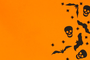 Flat lay halloween composition on orange background.