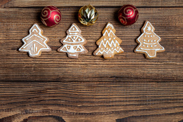 Handmade cookies Christmas spruce toys on a dark wooden dark background. The concept of preparing for the holidays New Year and Christmas.