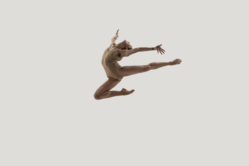 Modern ballet dancer. Contemporary art ballet. Young flexible athletic woman.. Studio shot isolated...