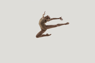 Modern ballet dancer. Contemporary art ballet. Young flexible athletic woman.. Studio shot isolated on white background. Negative space.