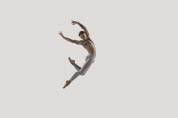 Modern ballet dancer. Contemporary art ballet. Young flexible athletic man.. Studio shot isolated...