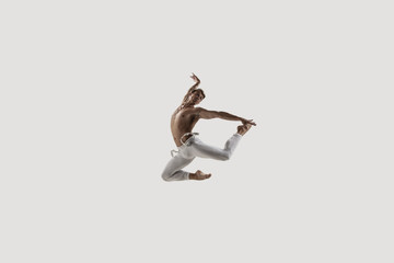 Modern ballet dancer. Contemporary art ballet. Young flexible athletic man.. Studio shot isolated on white background. Negative space.