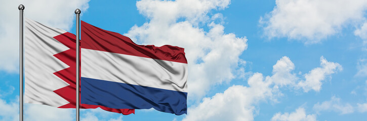 Fototapeta na wymiar Bahrain and Netherlands flag waving in the wind against white cloudy blue sky together. Diplomacy concept, international relations.