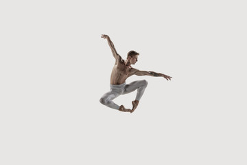 Fototapeta na wymiar Modern ballet dancer. Contemporary art ballet. Young flexible athletic man.. Studio shot isolated on white background. Negative space.