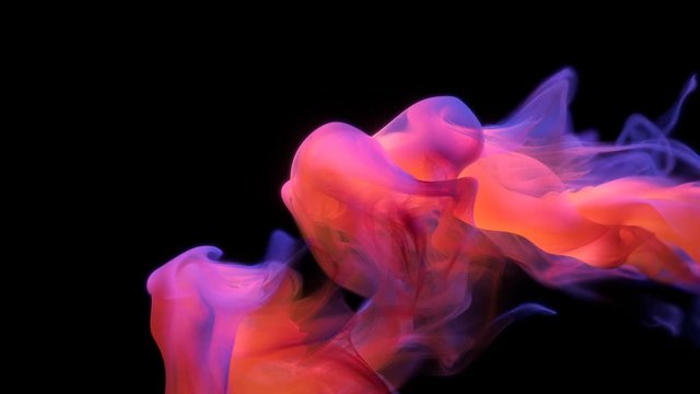 Orange purple color paint ink drops in water slow motion art background with copy space. Inky cloud swirling flowing underwater. Abstract smoke fluid liquid animation isolated on black alpha channel