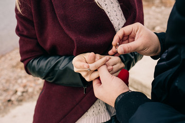 the guy makes an offer to the girl by the water