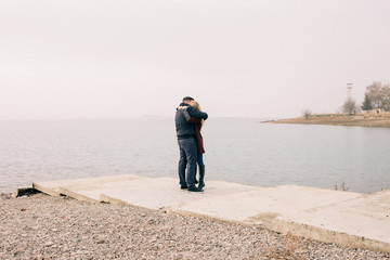 couple hugging on a pier