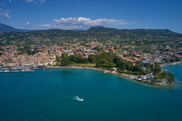 Fototapeta na wymiar Aerial photography. Beautiful coastline. In the city of Bardolino, Lake Garda is the north of Italy. View by Drone.