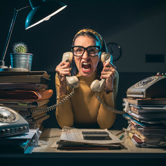 Stressed secretary shouting at the customers on the phone