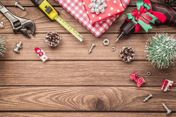 Merry Christmas and Happy New Years Handy Constrcution Tools background concept. Handy House Fix DIY handy tools with Christmas ornament decoration on wood table with copy space.