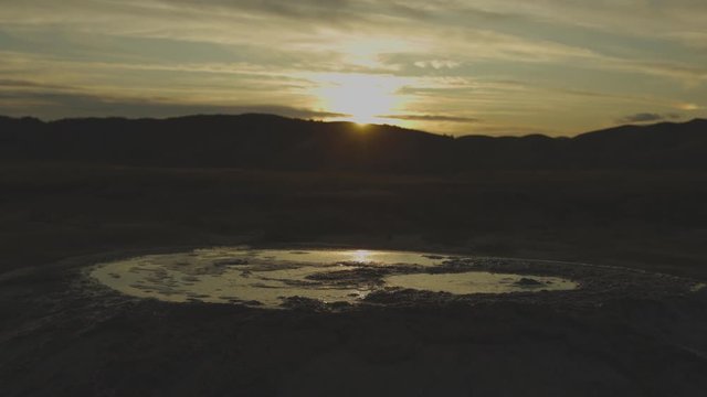 Sunset over volcanoes of mudd. Close up of a small volcano