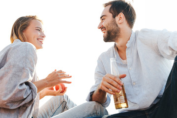 Cheerful young couple in love having picnic