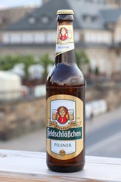 DRESDEN, GERMANY - MAY 10, 2018: Feldschlosschen pilsner beer bottle in Dresden. 1,300 breweries in Germany produce some 5,000 brands of beer.