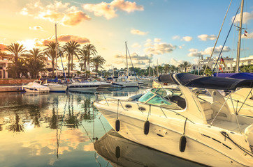 Luxury boats anchoring at the yacht marina of Cala D'or during sunrise, Mallorca, Spain.