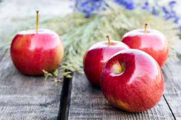Ripe red apples on a wooden table. Vitamins and a healthy diet. Vegetarian concept.