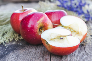 Fresh ripe red apples lie on a wooden table. Vitamins and a healthy diet. Vegetarian concept.