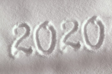 Abstract Christmas photo for beautiful Christmas card with background inscription 2020 on real white snow in winter in cold weather