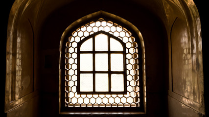 Fototapeta premium Light coming through the stone lattice window