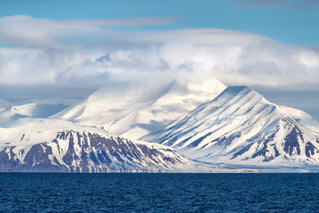 Snow covered mountains and icy fjords of Svalbard