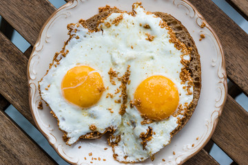 Fried Eggs with Sesame Seeds on Bread for Breakfast.