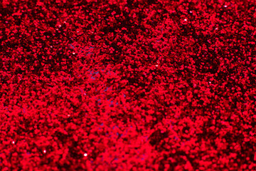 Red glitter texture. Festive sparkling sequins background closeup. Wpaper for Valentine, New Year or Christmas Holidays.