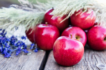 A lot of apples on a wooden table. Vitamins and a healthy diet. Vegetarian concept.