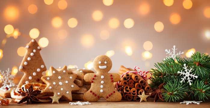 Gingerbread man and gingerbread cookie on bokeh background. Christmas banner.