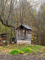 rural landscape with old buildings, naked tree silhouettes