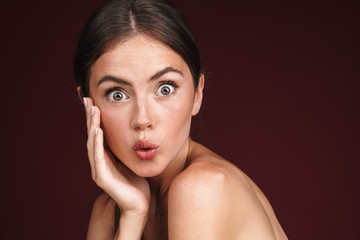 Image of half-naked woman expressing surprise and looking at camera