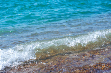 Soft wave of sea on sandy beach. Background.