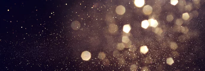 Foto op Plexiglas achtergrond van abstracte glitterlichten. goud en zwart. de gericht. banier © tomertu