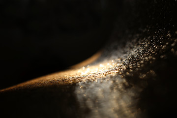 background of abstract glitter lights. gold and black. de focused