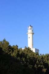 Fototapeta na wymiar Beacon of Lefkada island south cape lighthouse tower shine at sunlight in summer, clear blue sky at background
